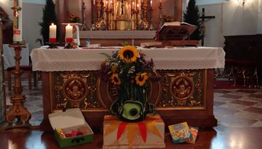 Family service with blessing of kindergarten and school bags